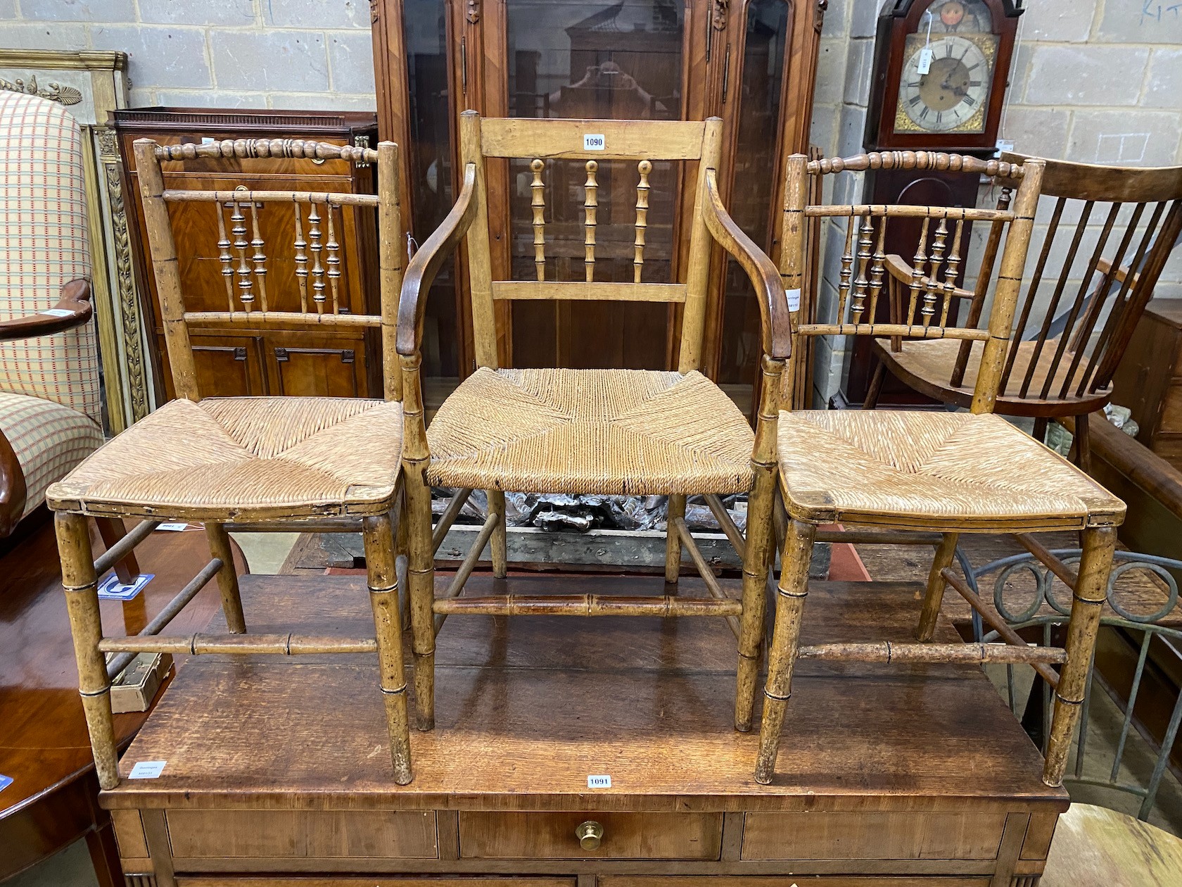 Three Regency painted rush seat chairs, one with arms, largest width 49cm, depth 40cm, height 74cm